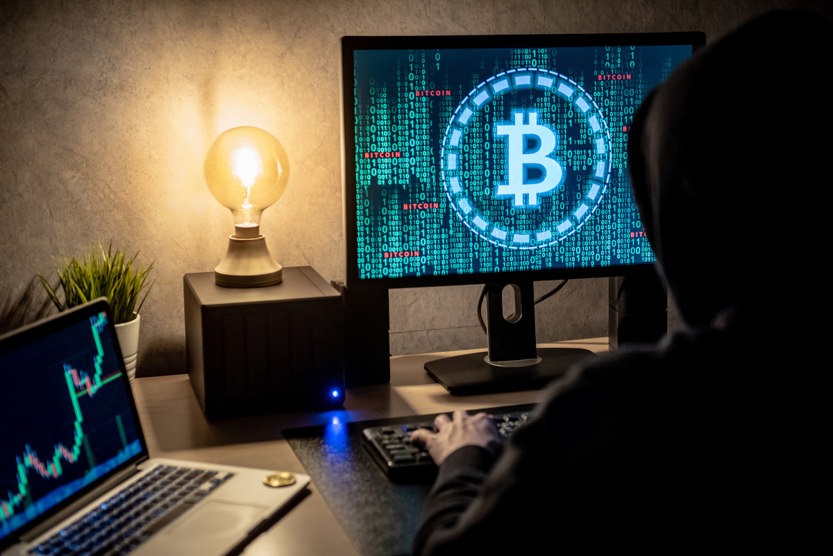 Hacker man using laptop and computer with Bitcoin. 